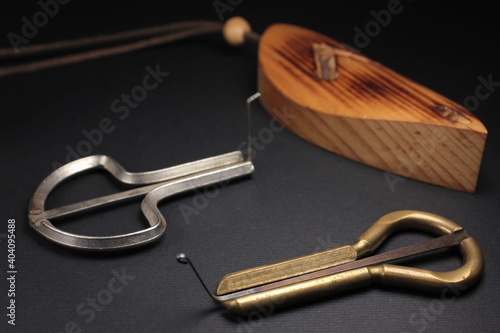 Two jew's harps, traditional music instruments of Altai and Yakut people, also known as carpathian drymba or vargan shot on a black background, close up view photo