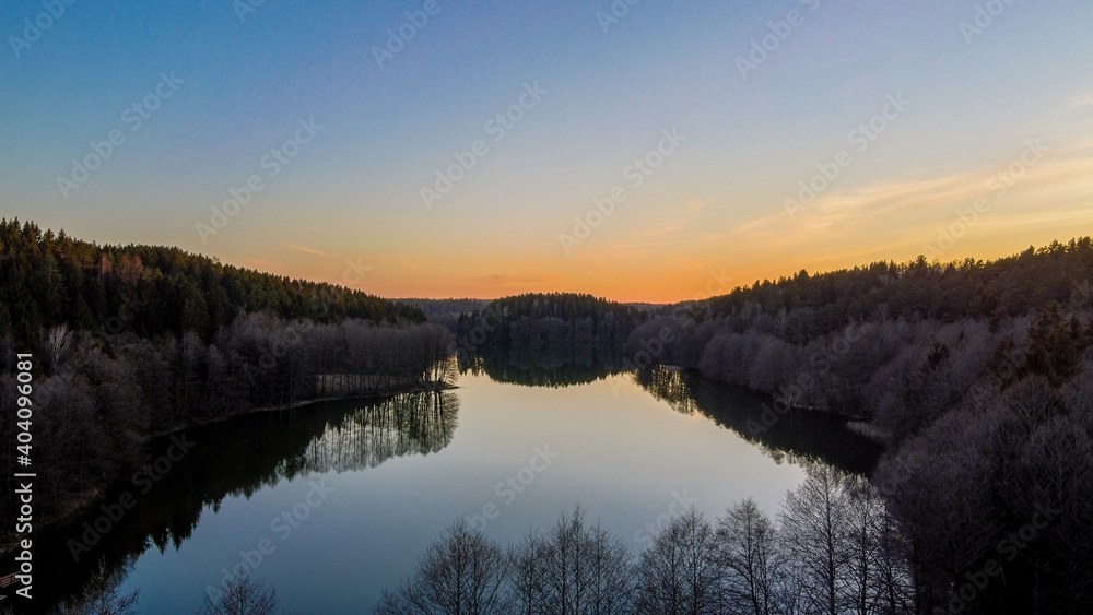 Aerial view of sunset and glass flat water by drone near lake Balsys