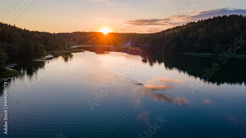 Aerial view of beautiful sunset in Lithuania near lake by drone