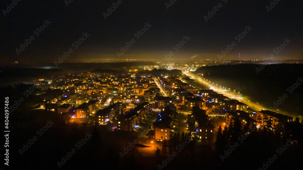 Aerial view of Santariskes living district in Vilnius at night by drone