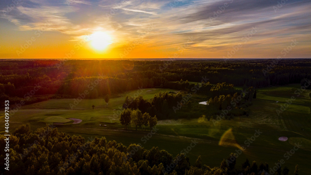 Obraz premium Aerial view of European centre golf club during sunset by drone
