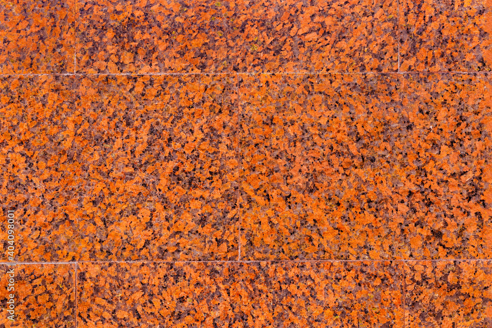 Texture of the wall with facing slabs of red, spotted, decorative, polished marble Texture of the wall with facing slabs of red, spotted, decorative, polished marble