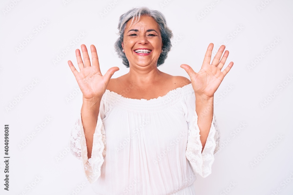Senior hispanic grey- haired woman wearing casual clothes showing and pointing up with fingers number ten while smiling confident and happy. Senior hispanic grey- haired woman wearing casual clothes showing and pointing up with fingers number ten while smiling confident and happy.