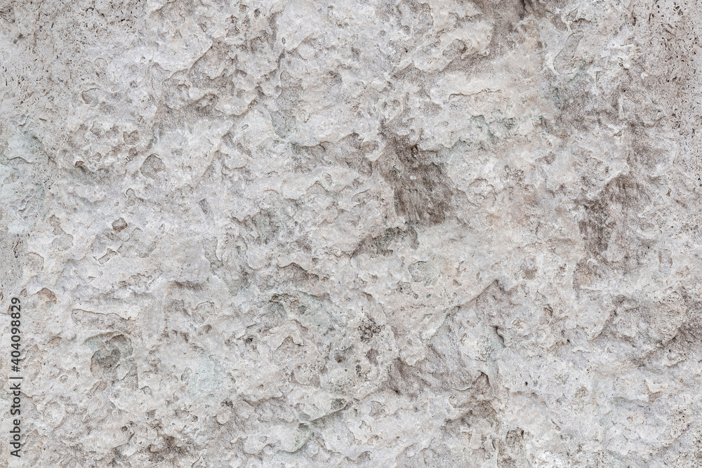 Rough, uneven texture stone of a gray concrete wall close up Rough, uneven texture stone of a gray concrete wall close up