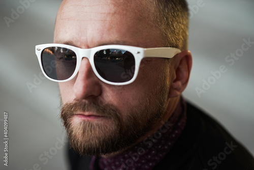 Bearded man portrait. Guy bearded in sunglasses. Close up of handsome bearded man sunglasses