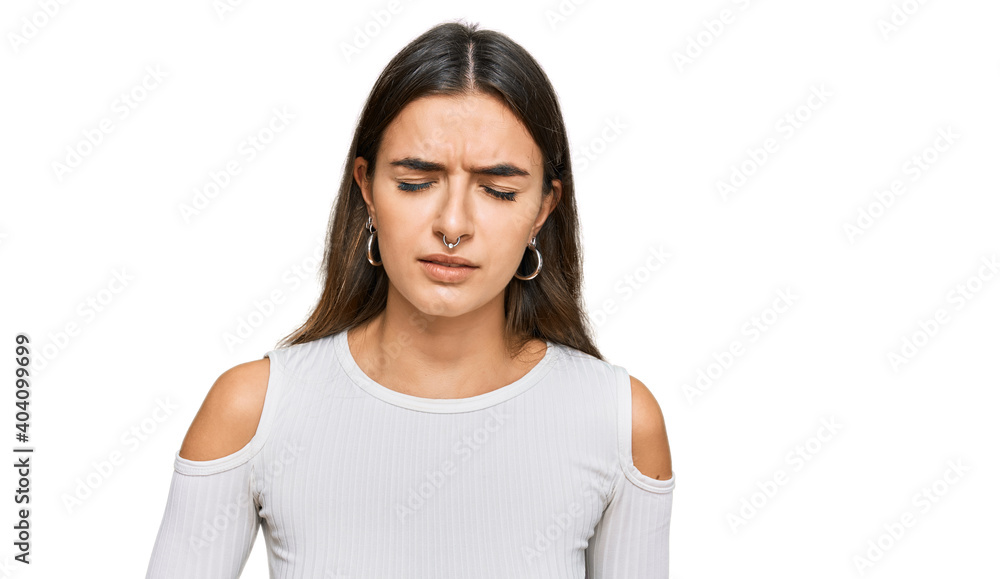 Young hispanic woman wearing casual clothes with hand on stomach because nausea, painful disease feeling unwell. ache concept. Young hispanic woman wearing casual clothes with hand on stomach because nausea, painful disease feeling unwell. ache concept.