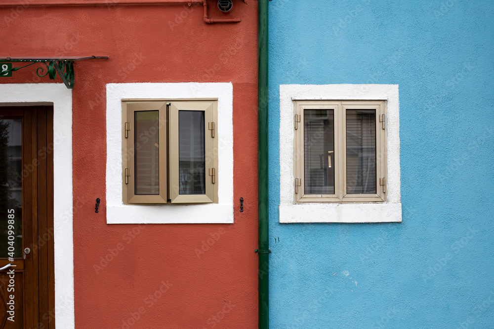 Red and blue building facade details in Burano Italy