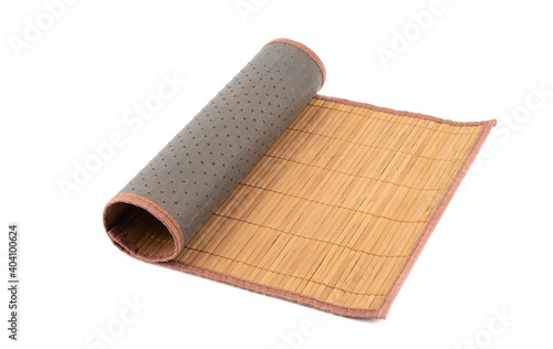 Rolled up bamboo food mat isolated on white background.