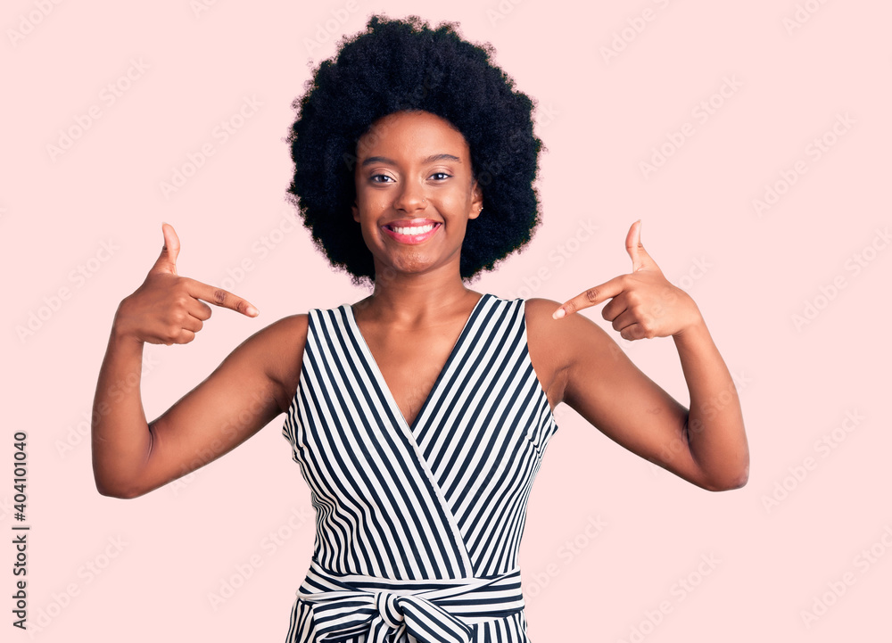 Young african american woman wearing casual clothes looking confident with smile on face, pointing oneself with fingers proud and happy. Young african american woman wearing casual clothes looking confident with smile on face, pointing oneself with fingers proud and happy.