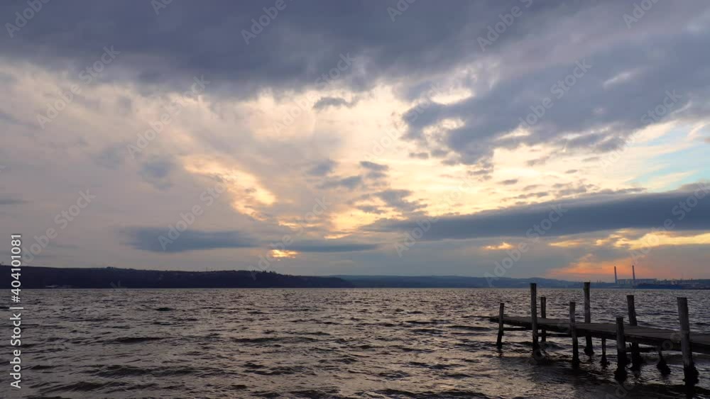 time lapse in the beautiful evening at the seashore with a wooden pier time lapse in the beautiful evening at the seashore with a wooden pier