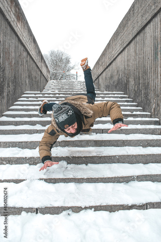person slipping and falling stairs during winter