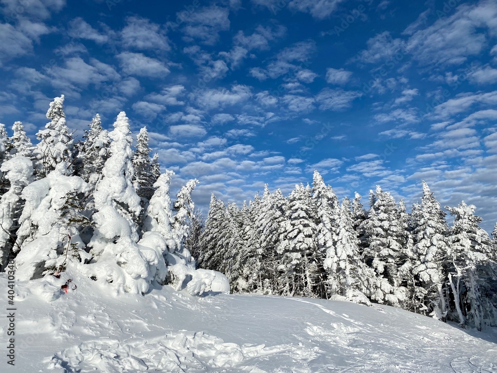 Beautiful sunny day with blue sky and white clouds at the Stowe Mountain Ski resort Vermont - December 2020