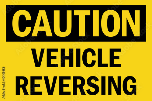 Caution vehicle reversing sign. Black on yellow background. Safety signs and symbols.