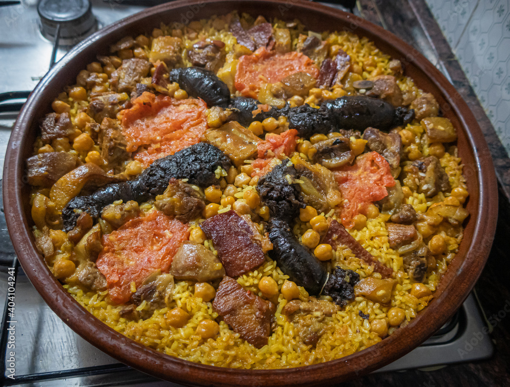 Baked rice, with chickpeas, blood sausage and various meats, typical dish of Valencia (Spain) Baked rice, with chickpeas, blood sausage and various meats, typical dish of Valencia (Spain)
