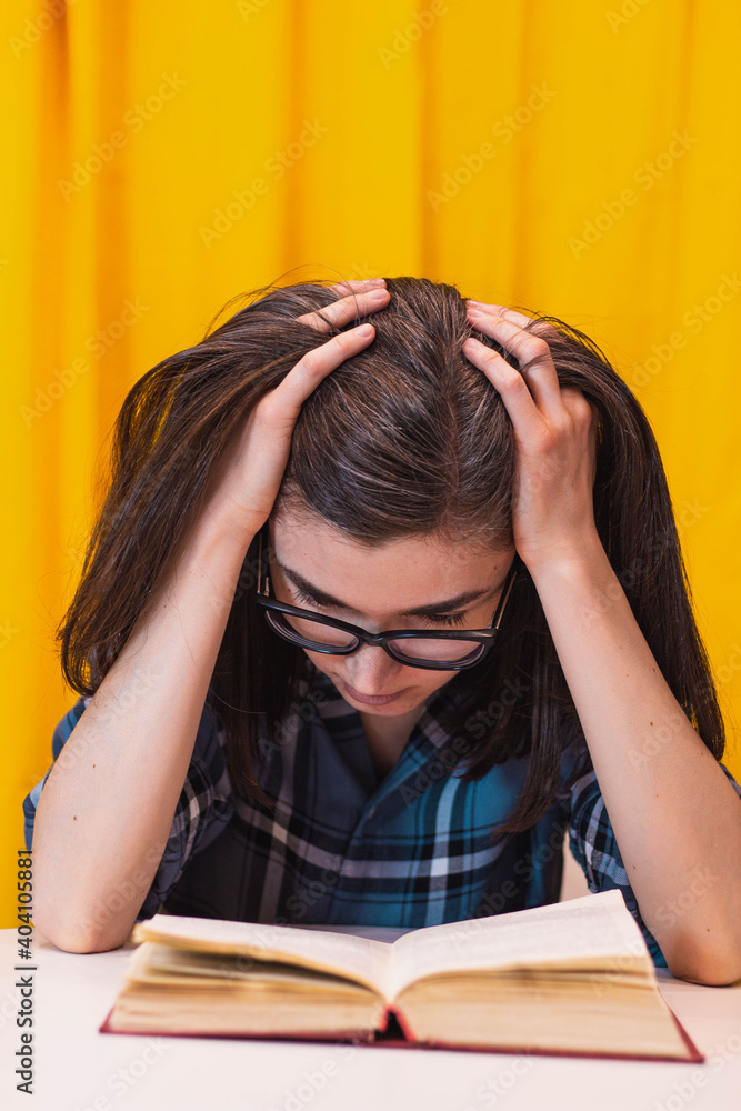 The girl reads a book at home. Preparing for studies. Gains knowledge. Teaches lessons and does assignments. Experiencing complexity The girl reads a book at home. Preparing for studies. Gains knowledge. Teaches lessons and does assignments. Experiencing complexity