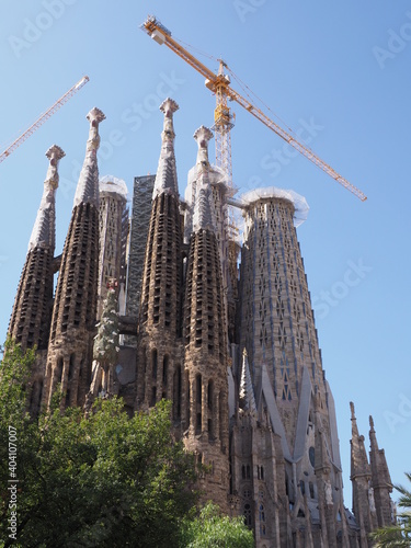 BARCELONA, SPAIN on SEPTEMBER 2019: Sagrada Familia cathedral under construction n european city at Catalonia district, clear blue sky in warm sunny summer day - vertical.