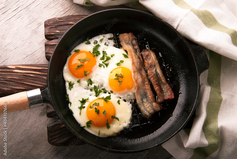 Scrambled eggs and bacon in a small pan Scrambled eggs and bacon in a small pan