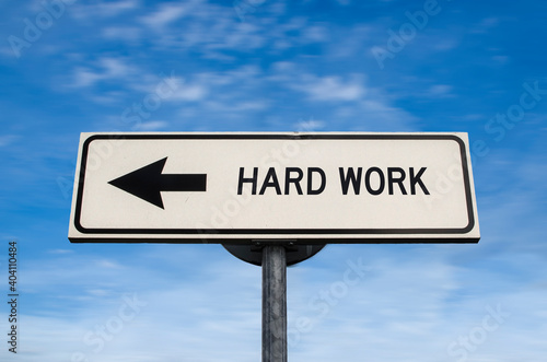 Hard work road sign, arrow on blue sky background. One way blank road sign with copy space. Arrow on a pole pointing in one direction.