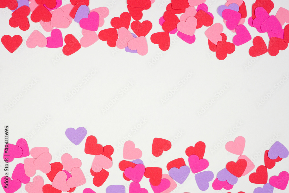 Valentines Day double border  with paper heart confetti. Top down view over a white background. Copy space.