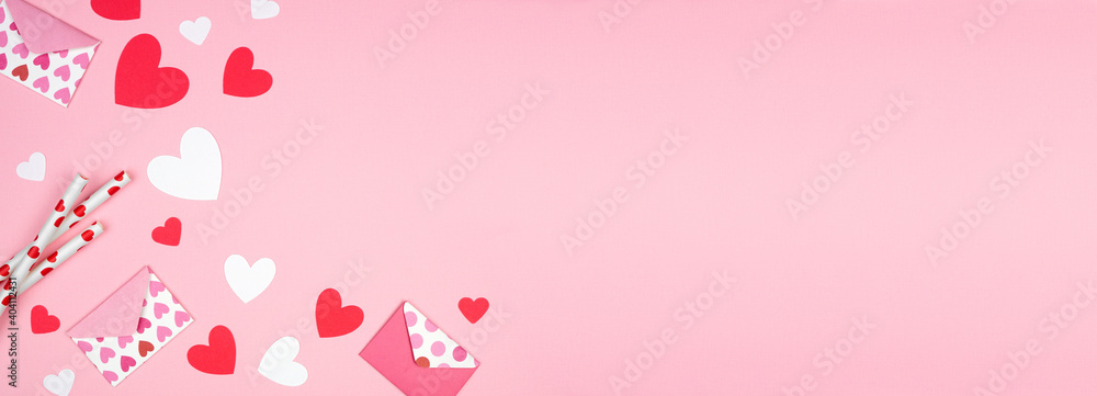 Valentines Day corner border of heart decorations. Top down view over a pink banner background. Copy space. Valentines Day corner border of heart decorations. Top down view over a pink banner background. Copy space.