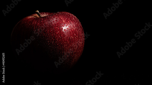 red apple on black background