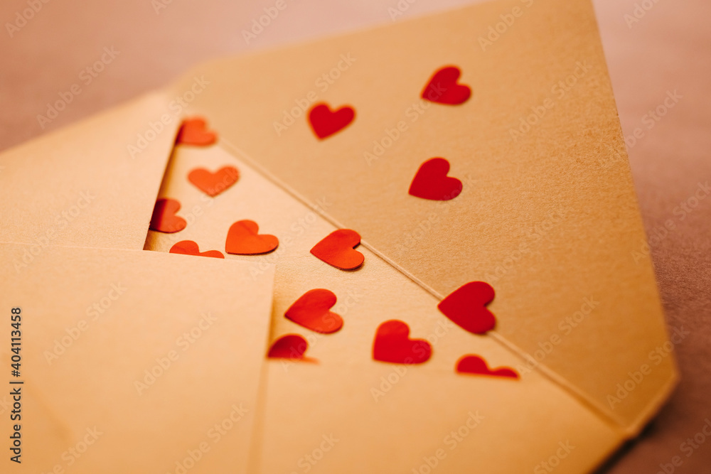 An open envelope full of lots of red hearts, closeup. An open envelope full of lots of red hearts, closeup.