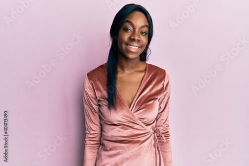 Young african american woman wearing sexy party dress with a happy and cool smile on face. lucky person. © Krakenimages.com