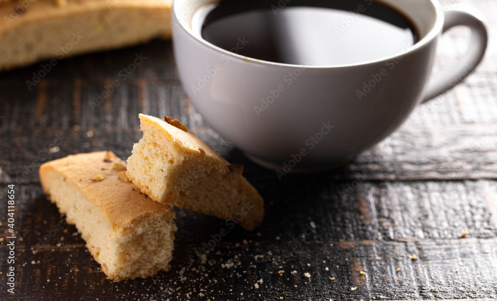 Almond and Walnut Biscotti wiht a Cup of Coffee on Rustic Wooden Table Almond and Walnut Biscotti wiht a Cup of Coffee on Rustic Wooden Table