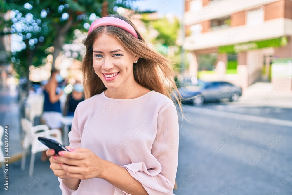 Young caucasian girl smiling happy using smartphone at the city. Young caucasian girl smiling happy using smartphone at the city.