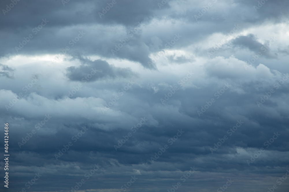 Natural color dramatic dark blue cloudy sky with wavy rippling clouds aligned above horizon, taken with wide angle 35 mm lens for sky replacement Natural color dramatic dark blue cloudy sky with wavy rippling clouds aligned above horizon, taken with wide angle 35 mm lens for sky replacement