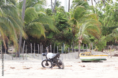 a motocycle, a boat and a forest