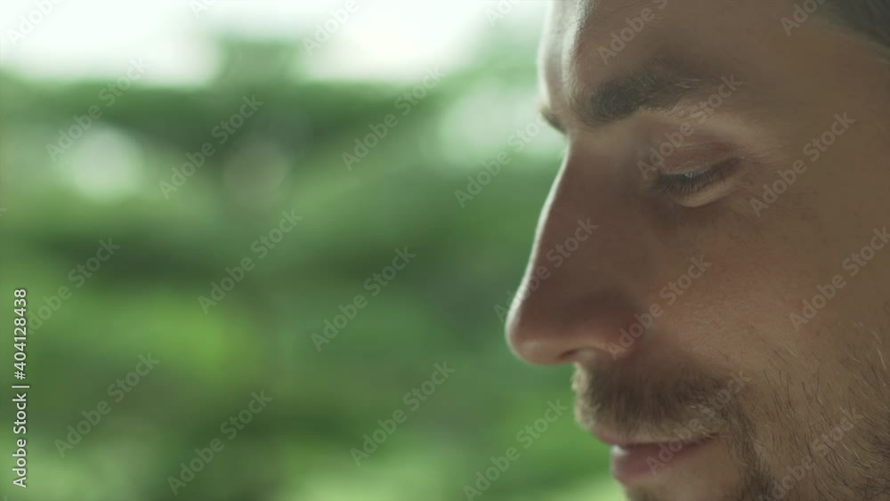 Сlose-up of a handsome man's face against a sunset background. Male profile on a nature background. For copy space. Сlose-up of a handsome man's face against a sunset background. Male profile on a nature background. For copy space.