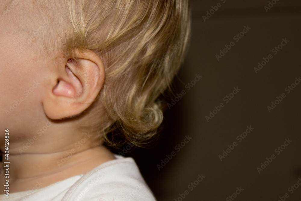 close up view of ear little white girl with curly hair and place for your text,kids ear,shape of humans organ of sense side view close up view of ear little white girl with curly hair and place for your text,kids ear,shape of humans organ of sense side view