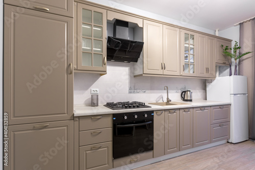 Interior photography, kitchen in light beige colors, with a window in a modern style