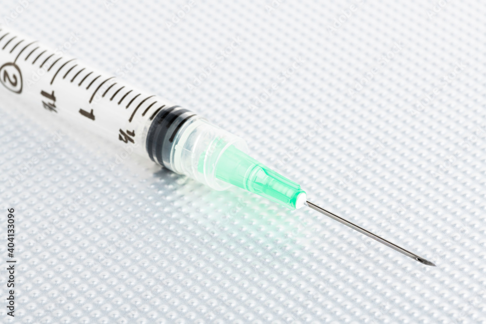Hygienic Single-Use Disposable Injection On Metal Background Hygienic Single-Use Disposable Injection On Metal Background