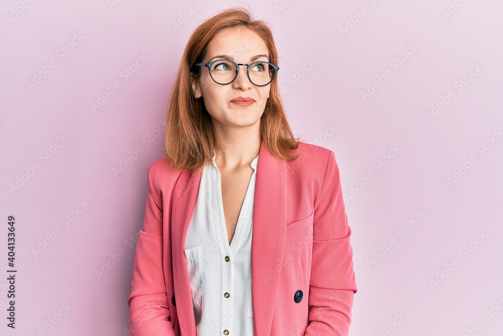 Young caucasian woman wearing business style and glasses smiling looking to the side and staring away thinking. Young caucasian woman wearing business style and glasses smiling looking to the side and staring away thinking.