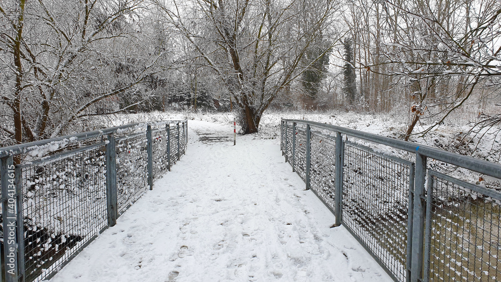 Bridge for pedestrians and cyclists over a river, concept of Christmas and winter walk