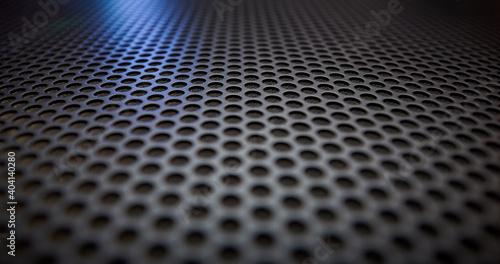 Black speaker grille texture as a background.