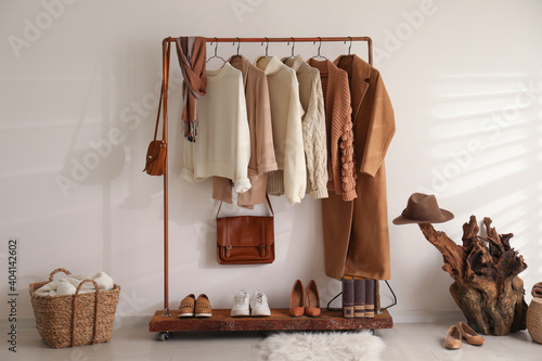 Modern dressing room interior with rack of stylish shoes and women's clothes photo