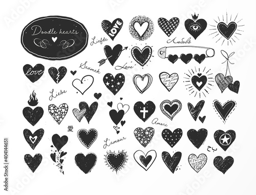 Collection of doodle sketch hearts on white background. "Love" inscription in different languages.