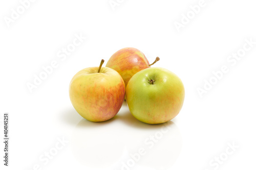 Three fresh yellow green apples isolated on the white background