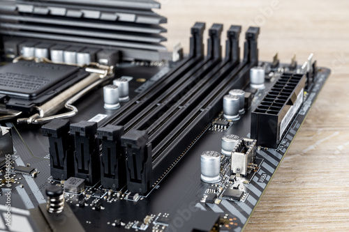 Four slots for ddr4 ram memory modules on a modern black pc motherboard. Computer mainboard circuit components. Desktop hardware close-up. PC components for assembly, upgrade and repair.