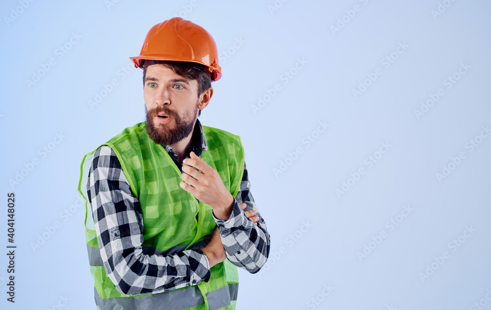 an architect in a helmet and a reflective vest gestures with his hands Copy Space an architect in a helmet and a reflective vest gestures with his hands Copy Space