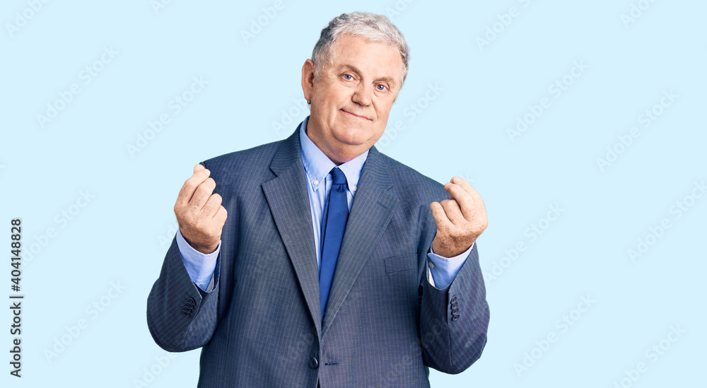 Senior grey-haired man wearing business jacket doing money gesture with hands, asking for salary payment, millionaire business Senior grey-haired man wearing business jacket doing money gesture with hands, asking for salary payment, millionaire business