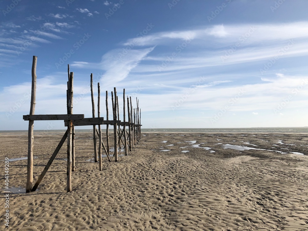 Wooden pillars or shapes on the beach of Vlieland, Friesland, The Netherlands Wooden pillars or shapes on the beach of Vlieland, Friesland, The Netherlands