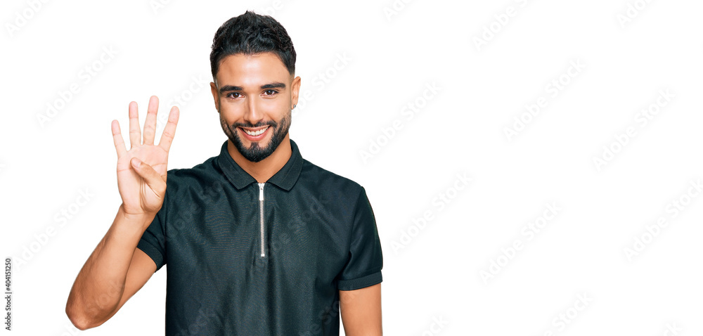 Young man with beard wearing sportswear showing and pointing up with fingers number four while smiling confident and happy. Young man with beard wearing sportswear showing and pointing up with fingers number four while smiling confident and happy.