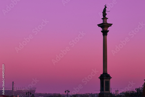 Statue of polish king Sigmund III Waza, on pink sky backround, old town in Warsaw