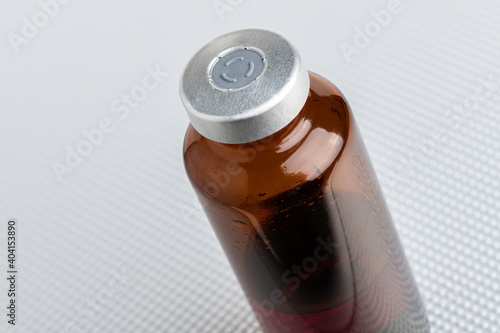 Macro Image Of Amber Vaccine Vial Set On Metal Background
