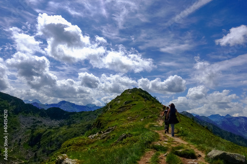 hikers on a path to a summit from a mountain