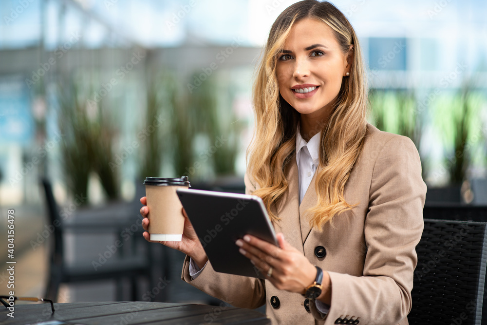 Blonde businesswoman using a digital tablet outdoor Blonde businesswoman using a digital tablet outdoor